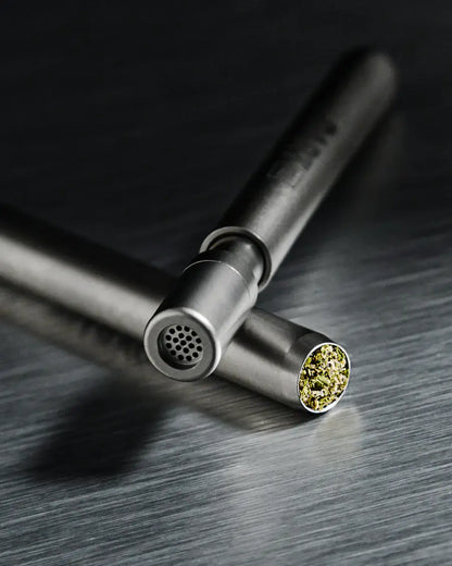 High-quality metal pipe from THE DART PLUS with yellow-green herb inside, designed for durability and ease of use.